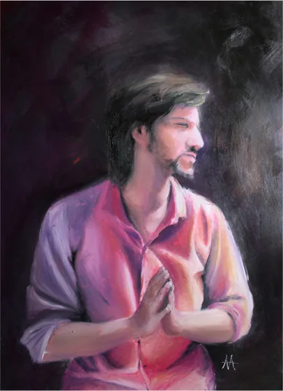 A man in a pink shirt with hands pressed together, on a dark ground