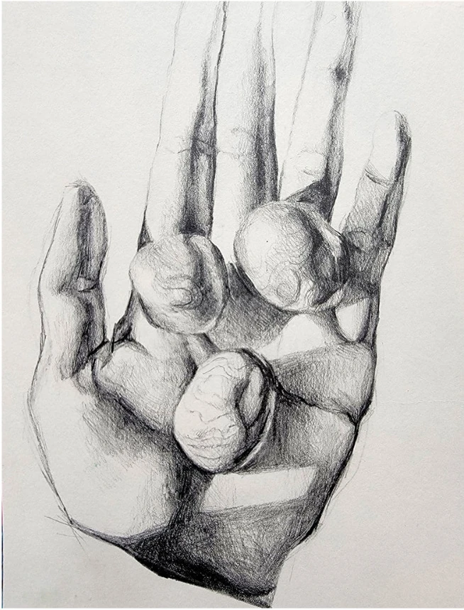 A hand holding round stones