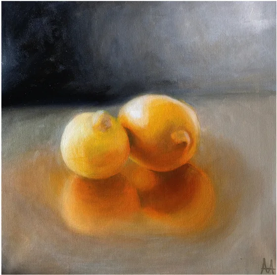 Three lemons on a dark ground with a warm glow