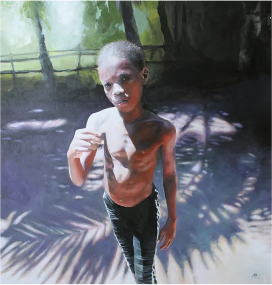 A boy standing in dappled shade under palm leaves